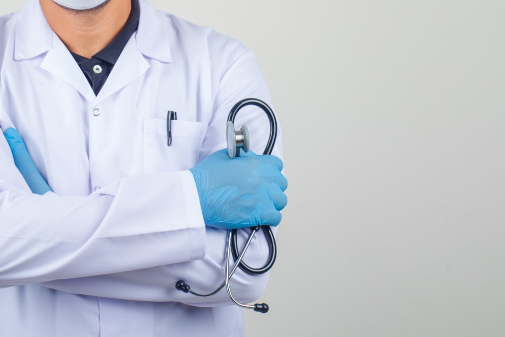 doctor crossing arms while holding stethoscope white coat 1